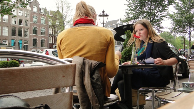 Waiting for a decadent eggs benedict at a popular cafe on the canal, and noting the naturally fashionable Dutch style.