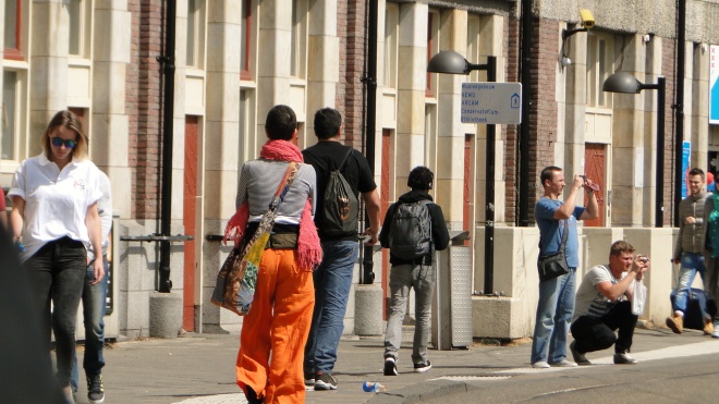 Downtown Amsterdam, orange pants and messenger bag.